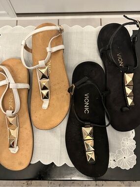 2 prs of Vionic T Strap sandals with gold accents. Size 7